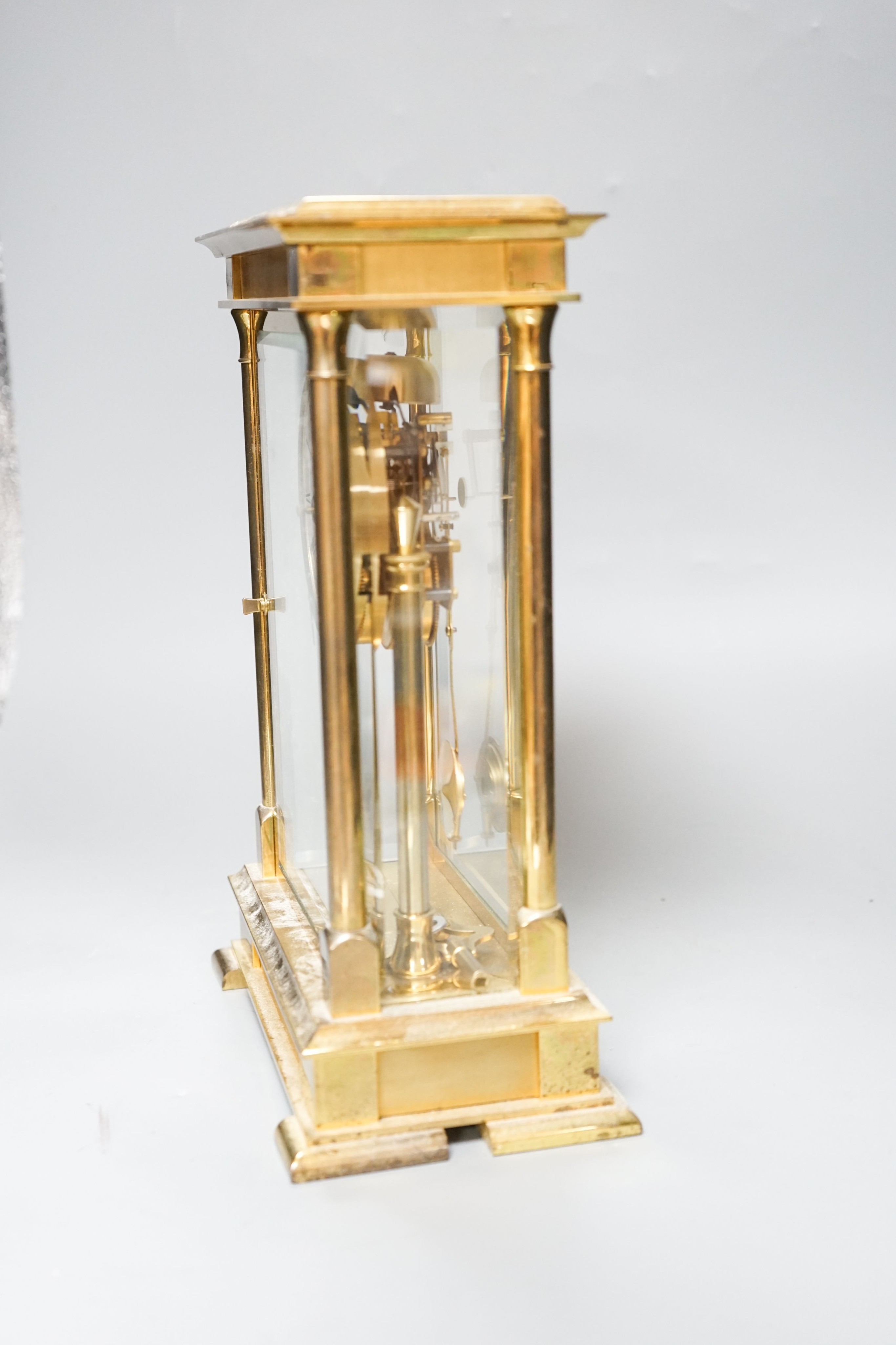 An 8 day brass cased clock 29cm